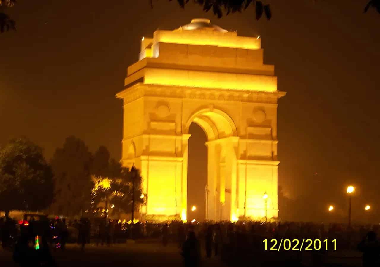India Gate illuminated at night in New Delhi. Location context only; this is not a portrait of Master Satya Brat.