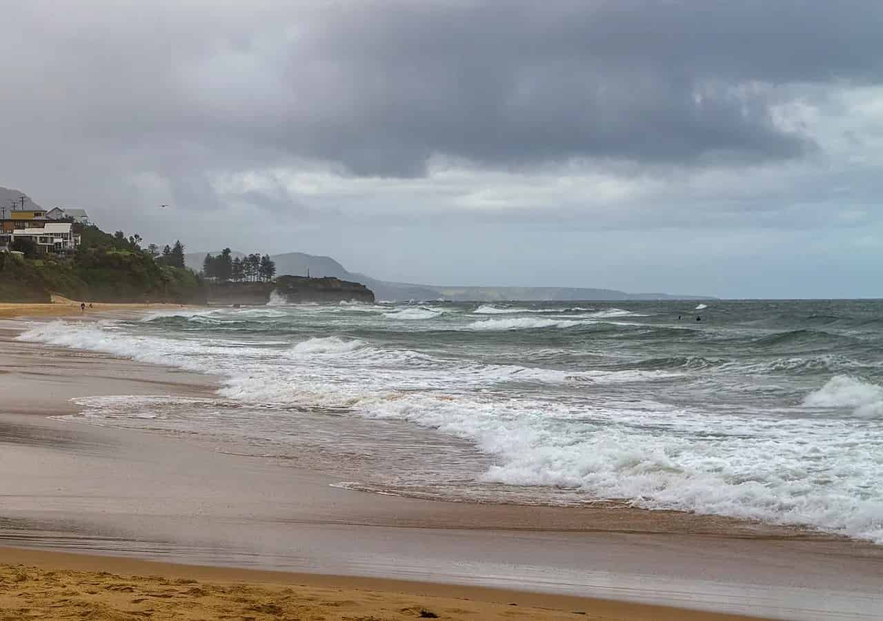 Beach and coastline at Thirroul, New South Wales. Location context only; this is not a photograph of Thirroul Yoga Shala.