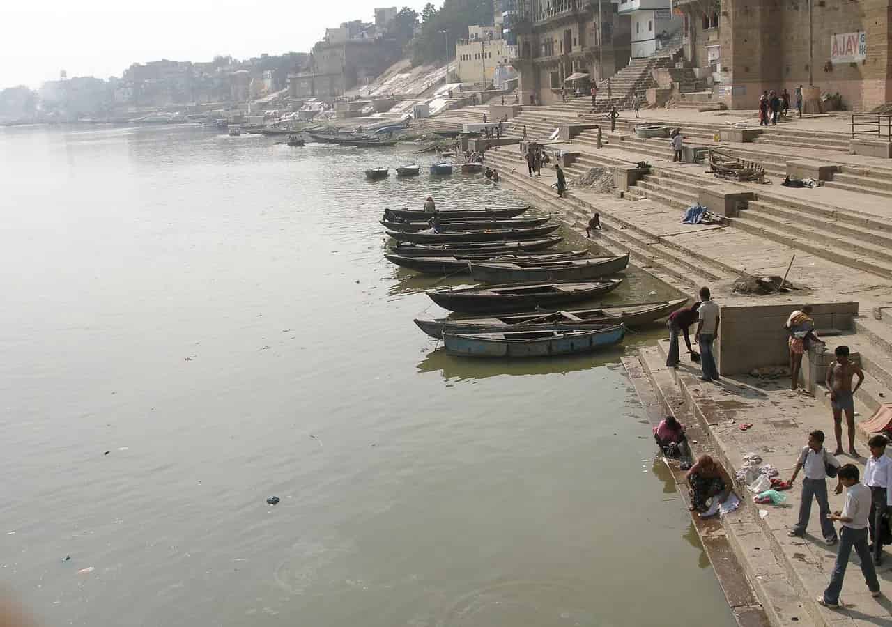 Historic riverside ghats and boats in Varanasi. Location context only; this is not a photograph of SiddhClaude Yoga Ashram (Varanasi).